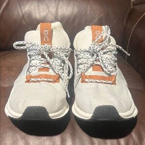 On Running White and Orange Sneakers with Modern Design